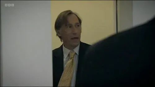 Screenshot: A man in his fifties hiding.