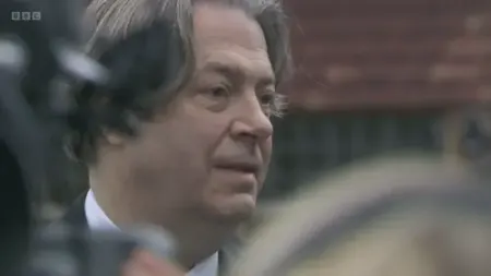 Screenshot: Minister, is that a bottle of champagne?