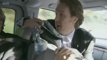 Screenshot: What's on your tie? Tintin moon rockets. Oh, for fuck's sake.